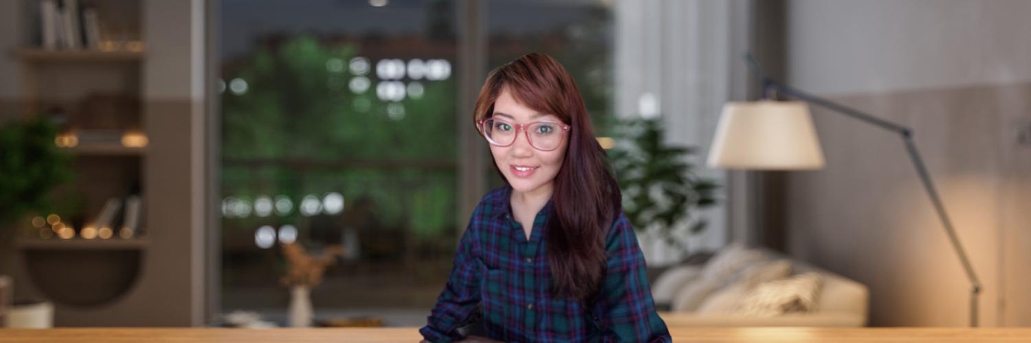 Voices of AH: Lisa: Education Photo of a female college student in a dimly lit dorm room.