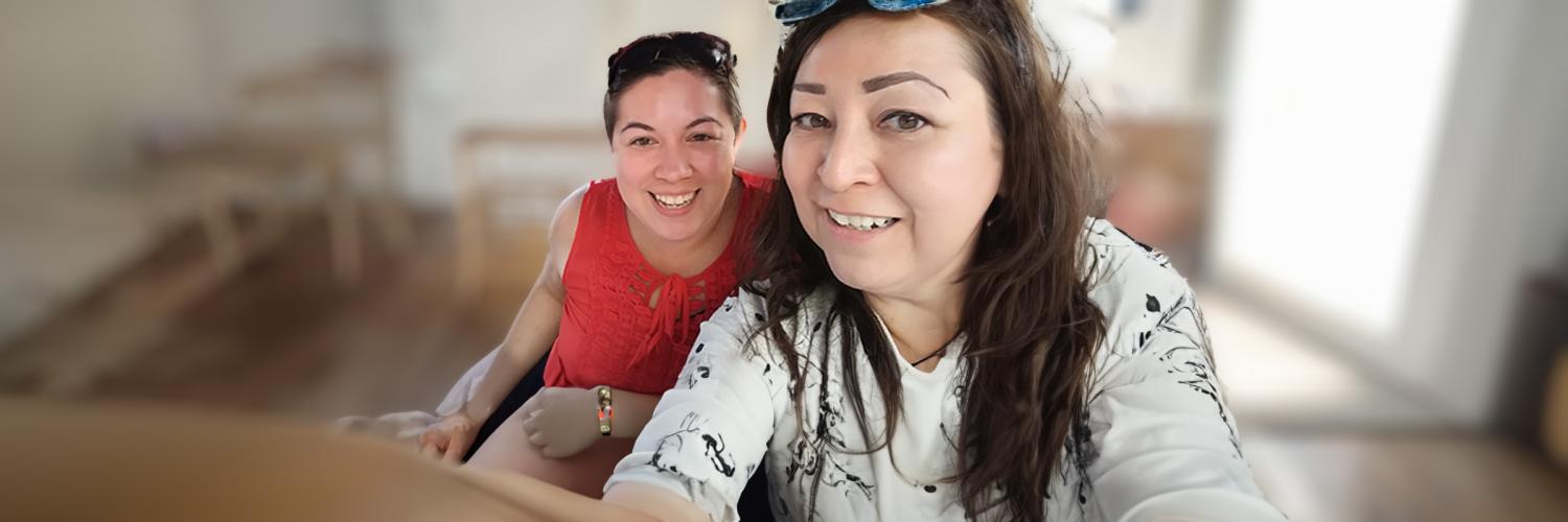 Voices of AH: Melissa Jennifer: Outreach Photo of two Health Care Authority staff, Jennifer (left) and Melissa (right), taking a self-portrait photo indoors.
