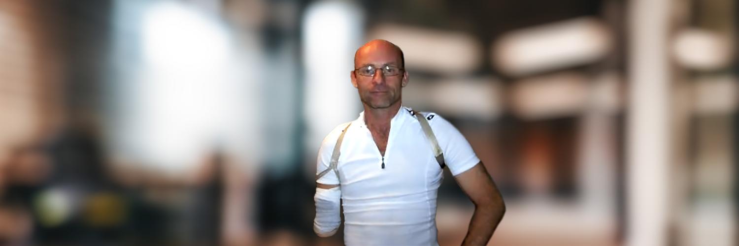 Voices of AH: Roger: Sense of security Photo of an Apple Health client, Roger, sitting in front of a blurred office background.