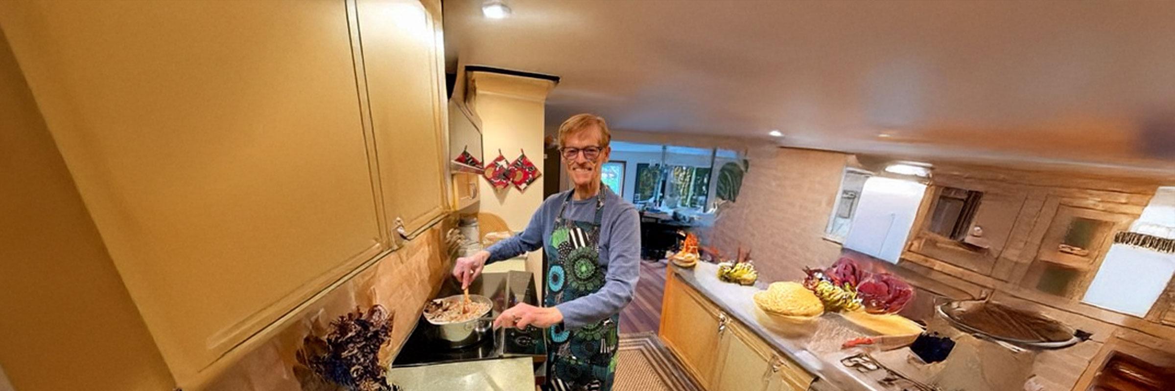 Dennis Goodwin stands in his kitchen making pasta.