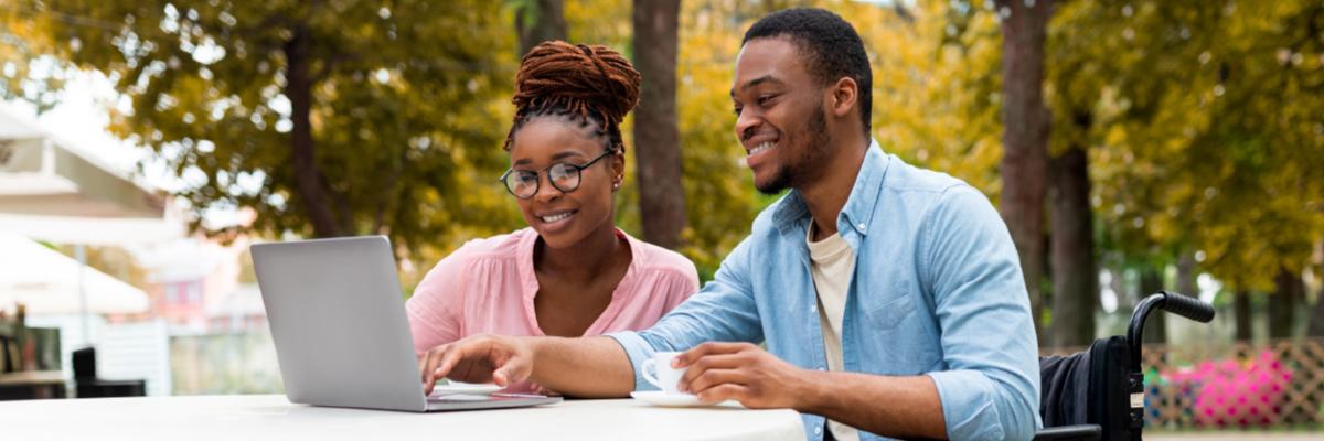 Two people looking at information on a laptop.