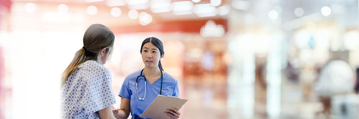 Female doctor discussing options with a female patient in a hospital setting