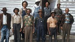 Group of black men in Tuskegee standing in front of a building.
