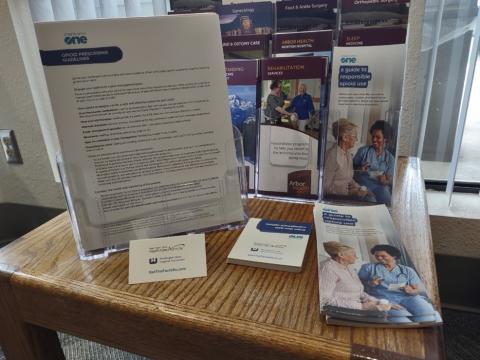 Starts with One campaign materials, including one pagers and brochures, on a small table.